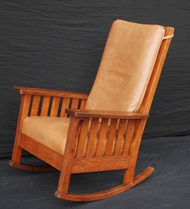 L & J G Stickley uncommon large high back rocking chair with slats under the arms, signed.